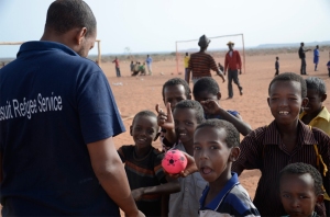 A Jesuit Refugee Service staff member meets with young refugees out for a game of soccer in Ethiopia. (Christian Fuchs : Jesuit Refugee Service:USA)
